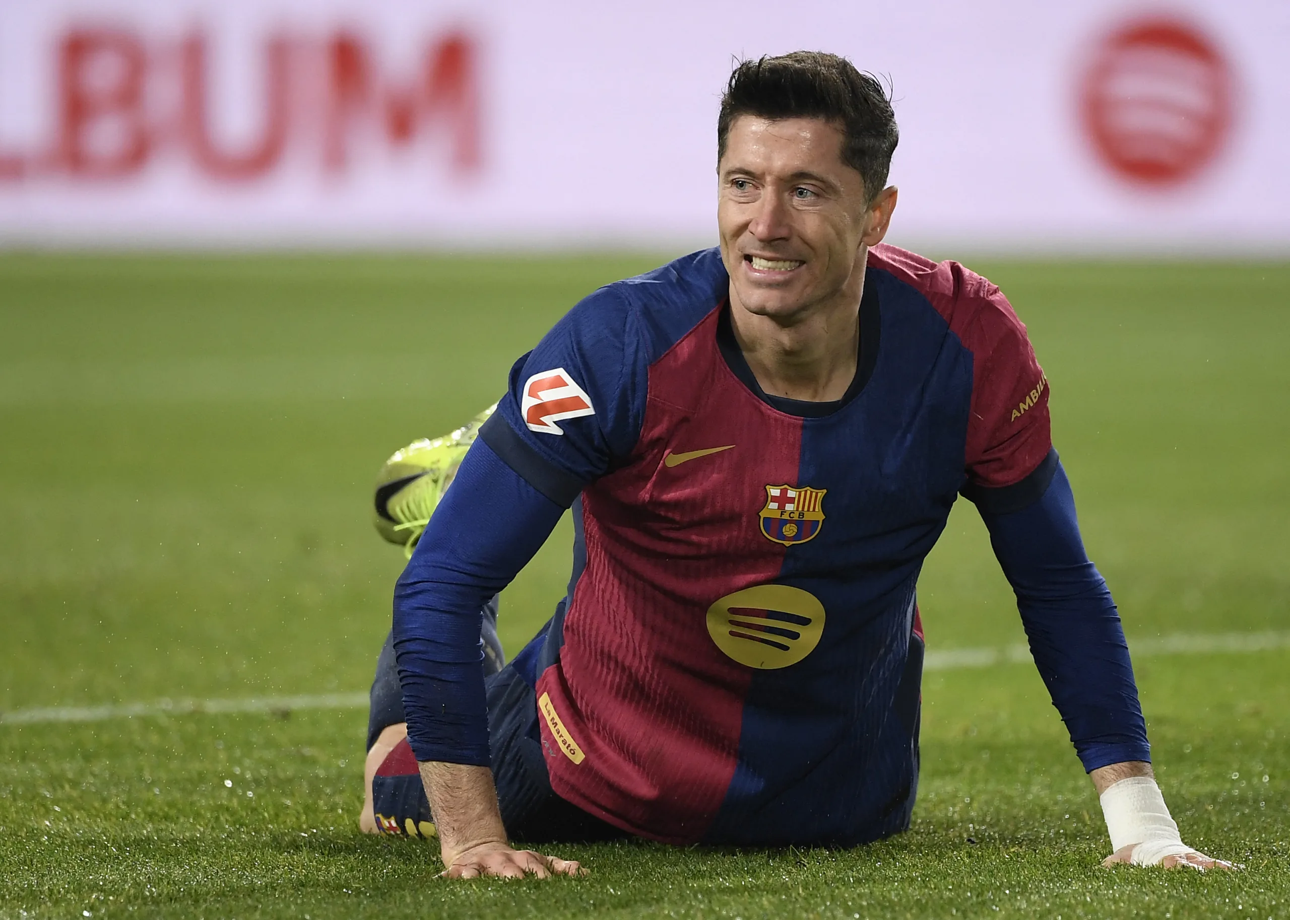 Barcelona's Polish forward #09 Robert Lewandowski falls on the ground during the Spanish league football match between FC Barcelona and Club Deportivo Leganes SAD at the Estadi Olimpic Lluis Companys in Barcelona on December 15, 2024. (Photo by Josep LAGO / AFP) FBL-ESP-LIGA-BARCELONA-LEGANES
